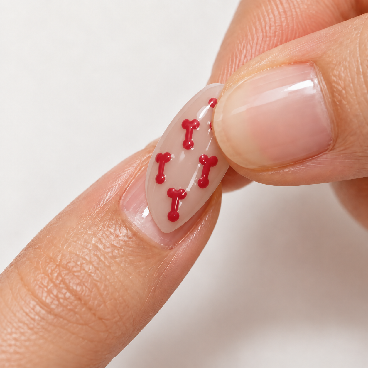 Pressing the exact Cherry red patterned STARE press-on firmly near the cuticle